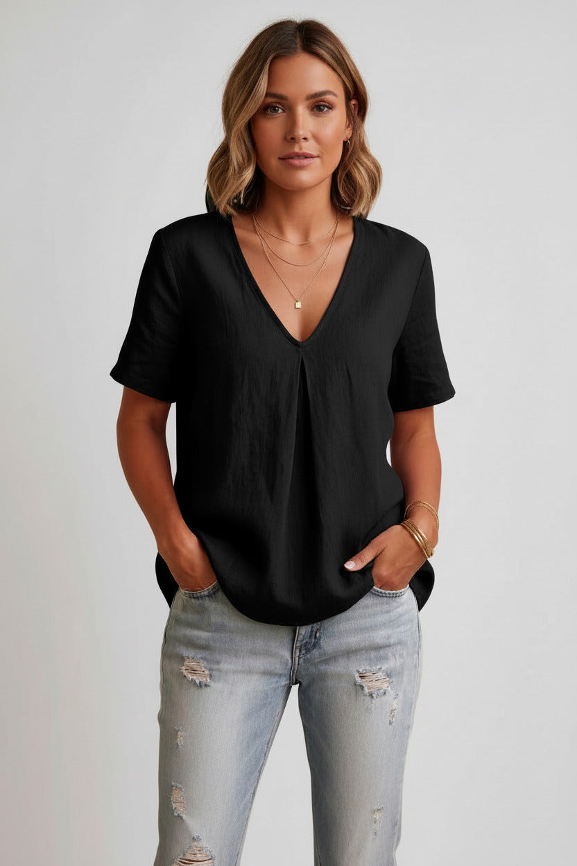 Person wearing a black t-shirt and ripped jeans on a white background