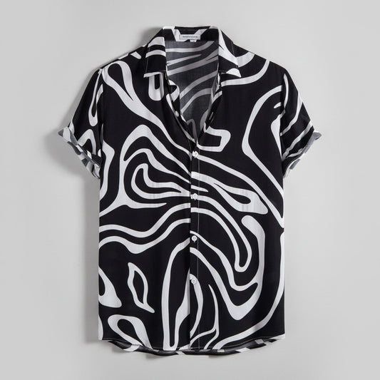 Black and white patterned shirt on a hanger with a white background