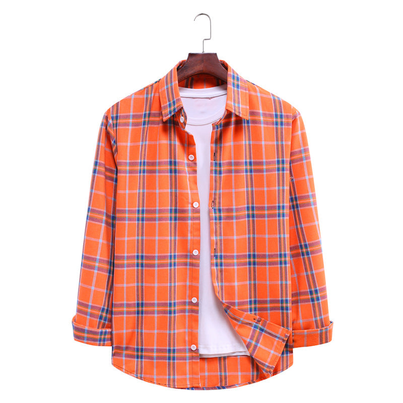 Orange and blue plaid shirt on a hanger against a white background