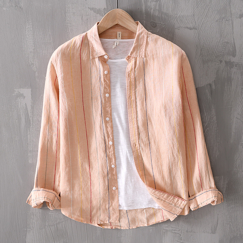 Light pink striped shirt over a white t-shirt on a wooden hanger against a gray textured wall.