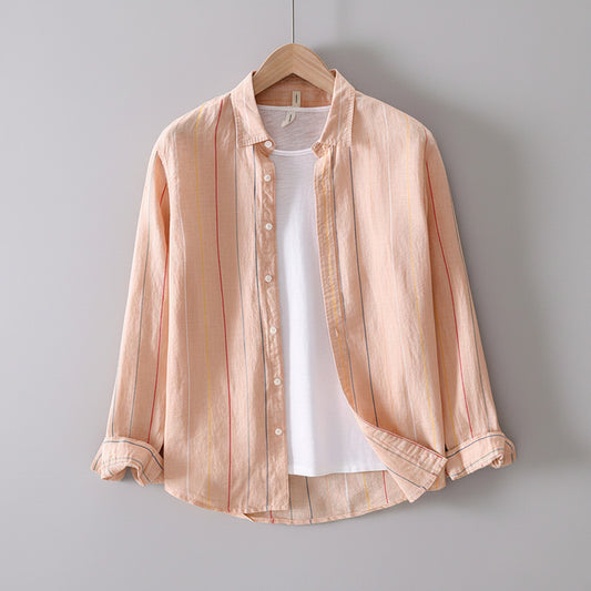 Light pink striped shirt over a white t-shirt on a wooden hanger against a gray textured wall.
