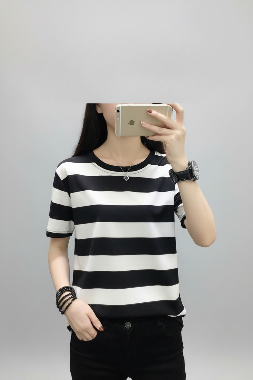 Person wearing a black and white striped shirt in a room setting.