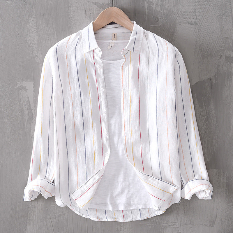 White striped shirt on a wooden hanger against a gray background