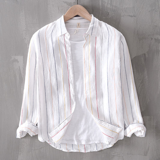 White striped shirt on a wooden hanger against a gray background