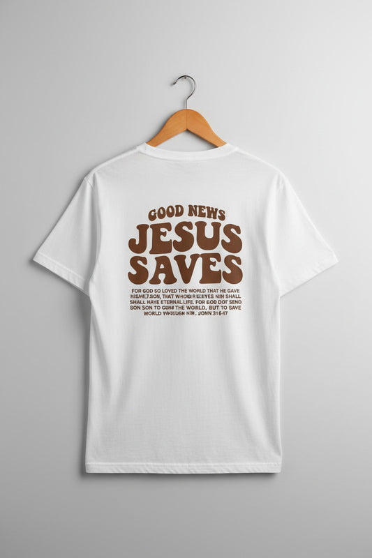White t-shirt with 'Jesus Saves' text on a wooden surface with shoes and newspaper.