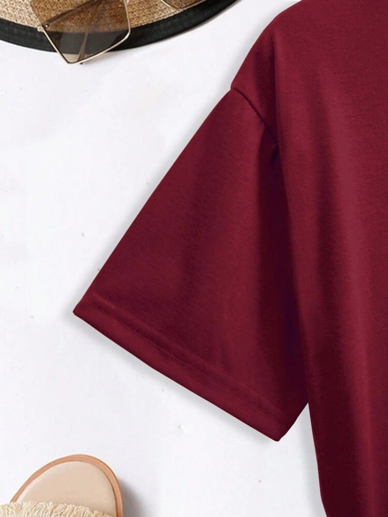 Maroon t-shirt on a white background with a hat and sandals.