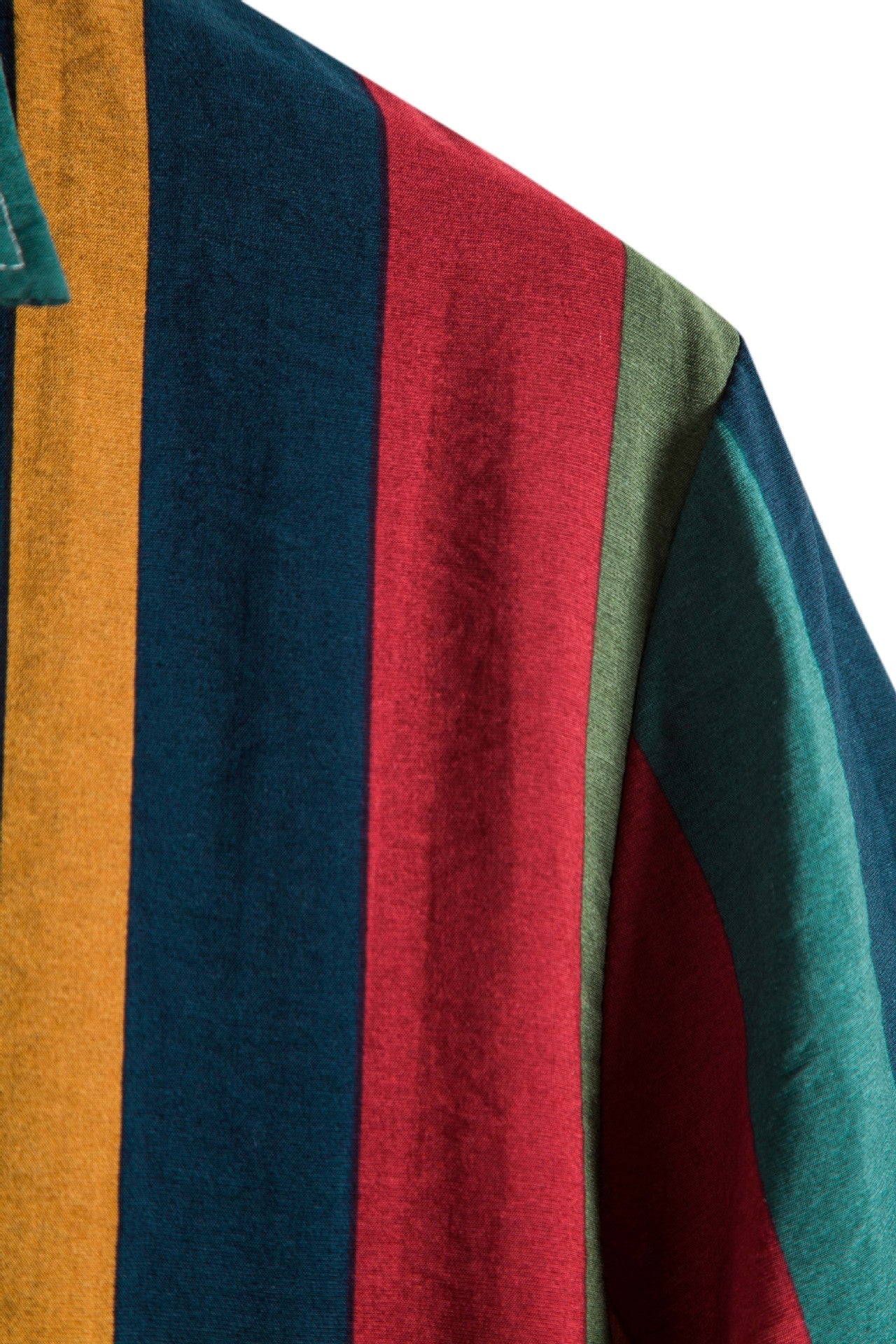 Close-up of a multicolored striped fabric with red, blue, green, and yellow stripes.