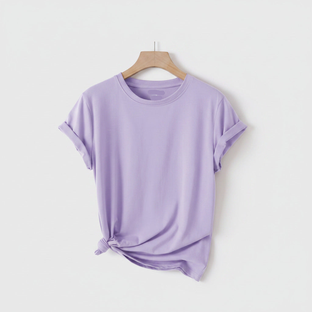Lavender t-shirt on a hanger with sandals, hat, and bag on a white background