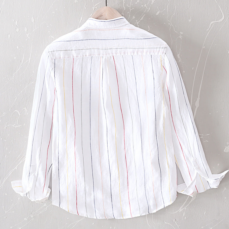 White shirt with colorful stripes on a gray textured background